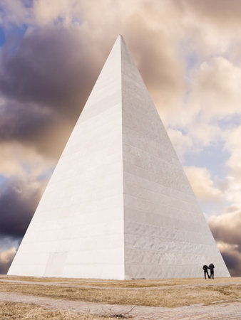 Pyramid on a background of the sky with silhouettes of peopleの写真素材