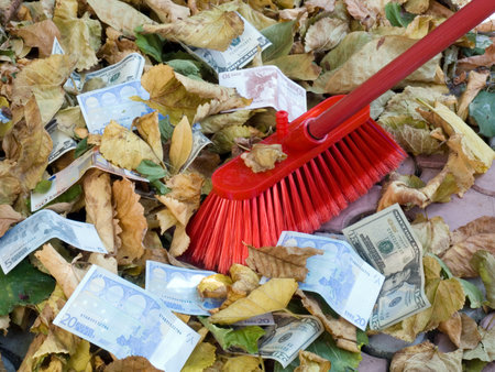 The American dollars and euro on a background of autumn leaves. Depreciation of currency. Crisisの写真素材