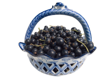 Berries of a black currant in a vase it is isolated on a white backgroundの写真素材