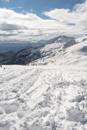 tracks leading on top of a mountain with ridge in the background