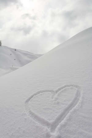 Heart drawn into the snowの写真素材