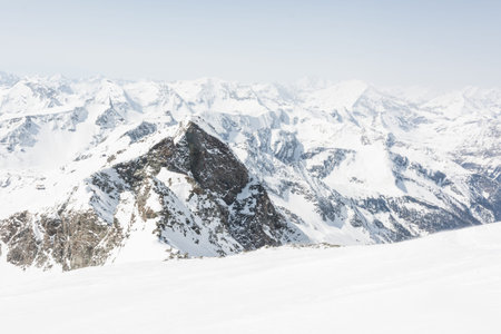 Snow covered slope in front of mountain ridge, view from Ankogel, Austria
