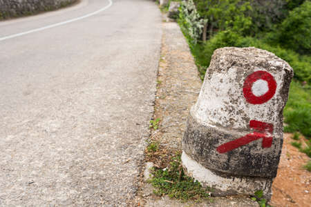 Round marker and arrow showing the way off roadの写真素材