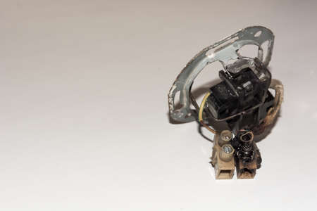 Damaged electrical socket with burn marks on a spot where came to short circuitの写真素材