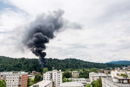 Smoke rising near residential buildings. Forest fire.の写真素材