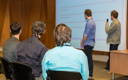 Conference and presentation. Audience listening to speaker.