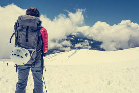 Female alpinist enjoying a mountain view. Close up of mountaineer.の写真素材