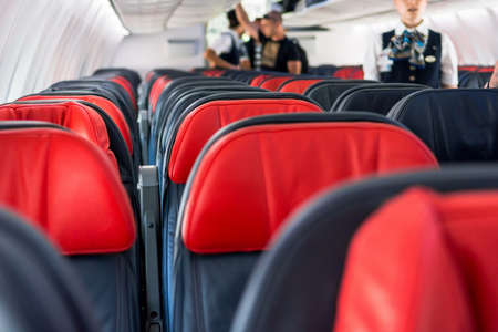 Airplane interior. Empty seats with red pillows.の写真素材