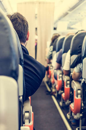 Airport interior. Businessman looking down the aisle.の写真素材