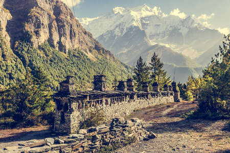 Buddhist praying wheels - Annapurna region. Mountains rising in the background.の写真素材