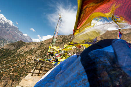 Praying blowing in the wind with mountain valley background. Annapurna circuit in Nepal.の写真素材