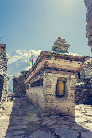 Buddhist praying wheels - Annapurna region. Traditional Nepali village.の写真素材