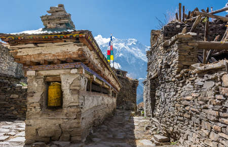 Buddhist praying wheels - Annapurna region. Traditional Nepali village.の写真素材