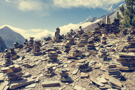 Stone piles with mountain on background. Annapurna circuit in Nepal.の写真素材