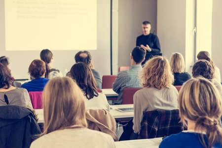 Person delivering a speach. Audience at a conference presentation.の写真素材