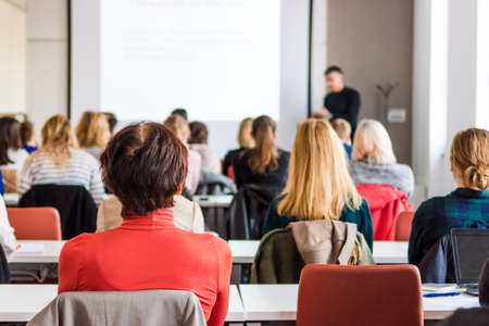 Audience at business conference. People listening to lecture.の写真素材