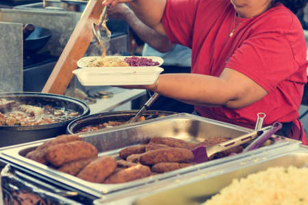 Indian dish served on open air kitchen stand. Street food photography.の写真素材