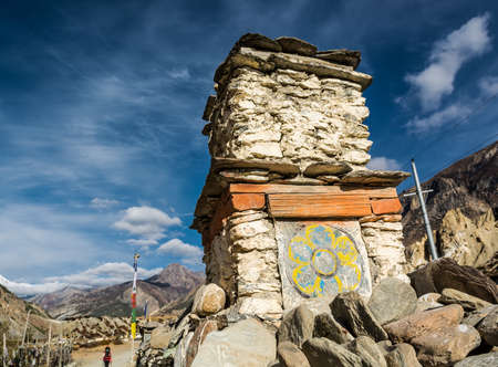 Buddhist drawing on a stone structure on trekking path. Annapurna region, Nepal.の写真素材
