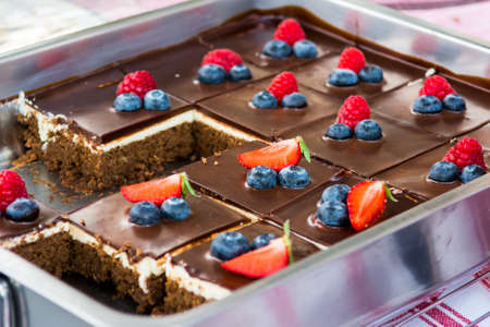 Tasty chocolate pastry with fresh berries. Street food photography on open kitchen event.の写真素材