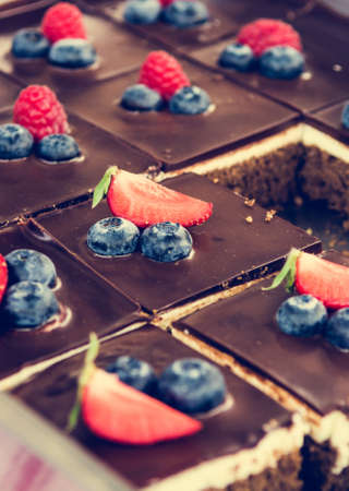 Tasty chocolate pastry with fresh berries. Street food photography on open kitchen event.の写真素材
