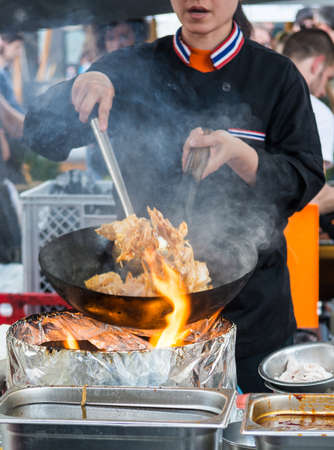 Chef making tasty noodles in a wok. Street food concept.の写真素材
