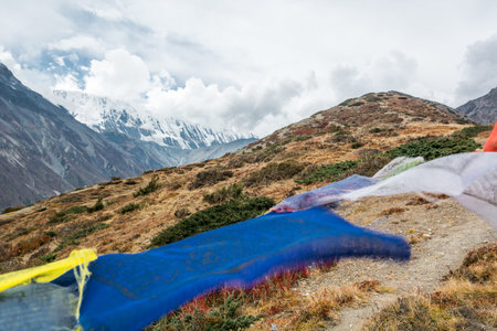 Buddhist praying flags blowing in the wind. Annapurna circuit in Nepal.の写真素材