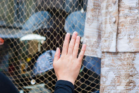 Hand pressed on store window. Window shopping concept.の写真素材
