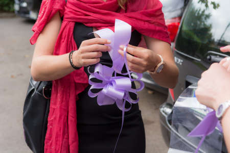 Wedding preparations, preparing purple ribbon. Celebrating eventの写真素材