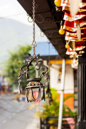 Dragon shapped candle holder hanging from a roof.の写真素材