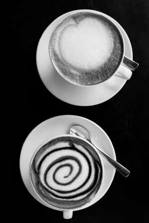 Two cups of coffe on wooden table.の写真素材