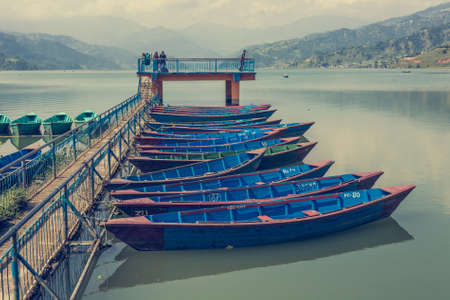 Colorful boats anchored to pier.の写真素材