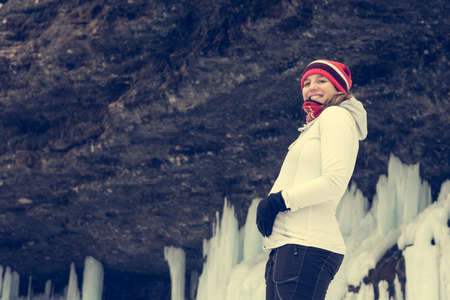 Young pregnant woman smiling on winter landscape.の写真素材