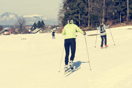 Couple of girls having fun on cross country skiing track.