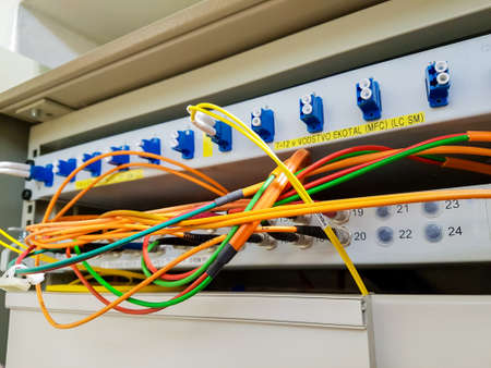 Closeup of fiber optic cable plugged into switch.の写真素材