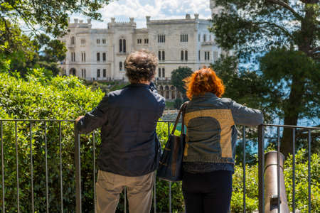 Adult couple admiring a sea castle.の写真素材