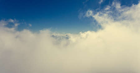 Aerial flying above clouds.の写真素材
