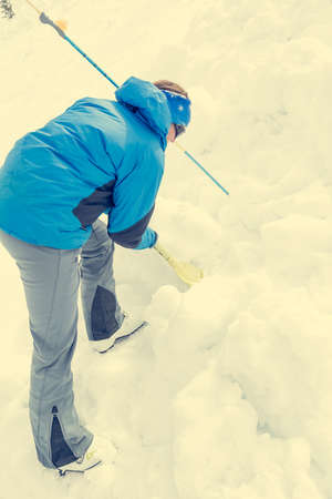 Female rescuer searching for avalanche victim.の写真素材