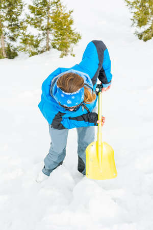 Female rescuer searching for avalanche victim.の写真素材
