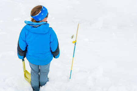 Female rescuer searching for avalanche victim.の写真素材
