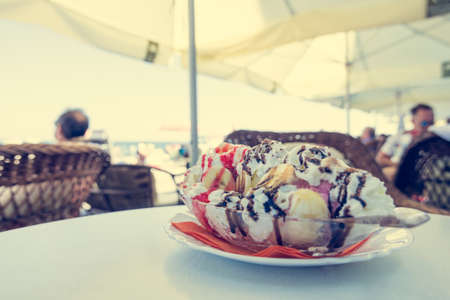 Delicious banana split ice cream. Cup of tasty desert at beach restaurant.の写真素材