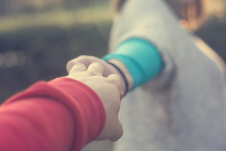 Couple female hands guiding her boyfriend.