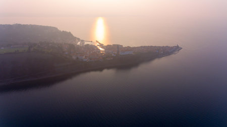 Aerial view of mediterranean coastal town at sunset.