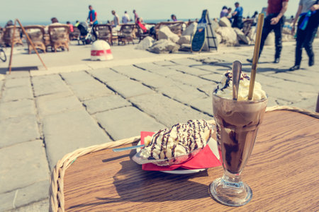 Enjoying ice coffee with banana split ice cream.