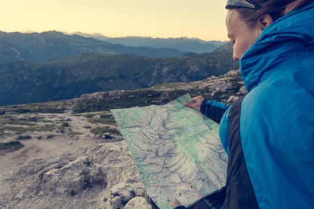 Female trekker studying a map.