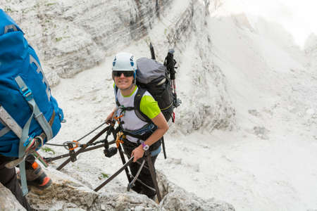 Happy climber reaching the summit of ladder.の写真素材