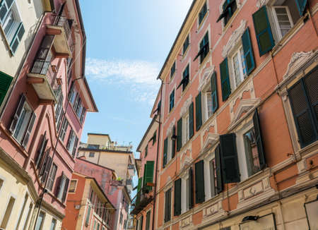 Old building with red facade and green windows.の写真素材