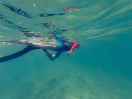 Male diver swimming in ocean enjoying summer.の写真素材