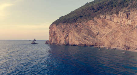 Aeriel view point of sheer cliffs raising from the sea.の写真素材