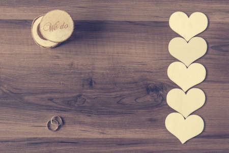 Wedding rings with line of hearts on wooden desk and a box.の写真素材