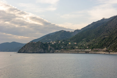 Ocean view with evening sun illuminating curvy coastline.